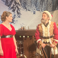 scene from the Christmas Express, a NYC holiday show, showing Santa and Mrs. Claus