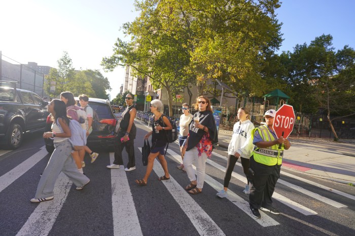 people walking across a crosswalk in NYC