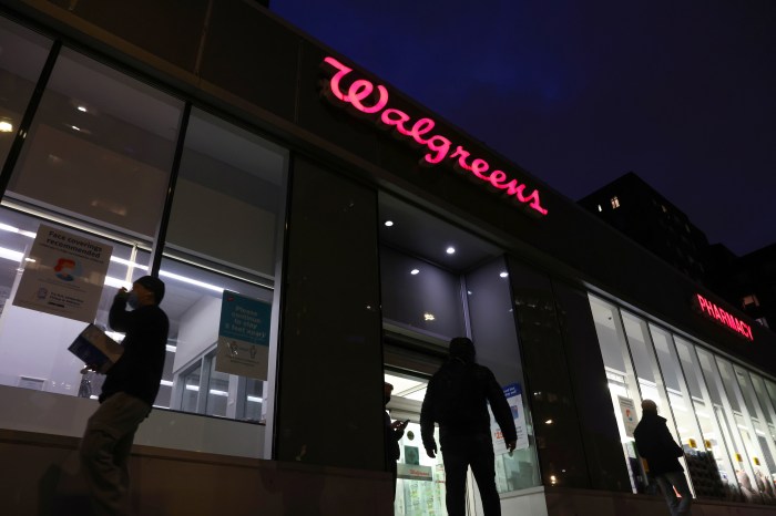 People walk by a Walgreens, owned by the Walgreens Boots Alliance, Inc., in Manhattan, New York City, U.S., November 26, 2021.