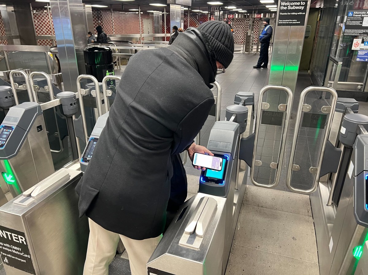 Man using open MTA turnstiles