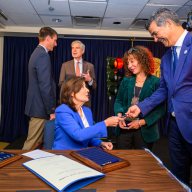 Gov. Kathy Hochul signs red light camera law, hands pen to transportation commmissioner