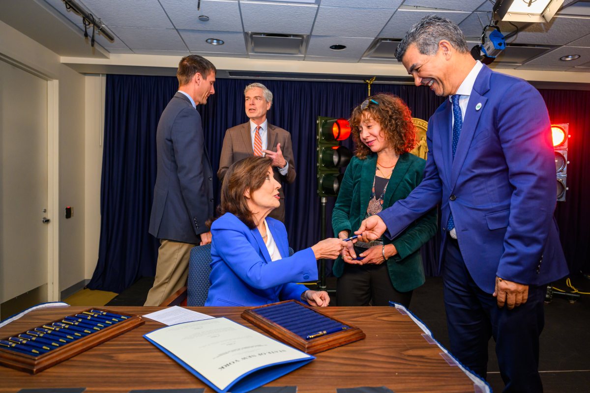 Gov. Kathy Hochul signs red light camera law, hands pen to transportation commmissioner