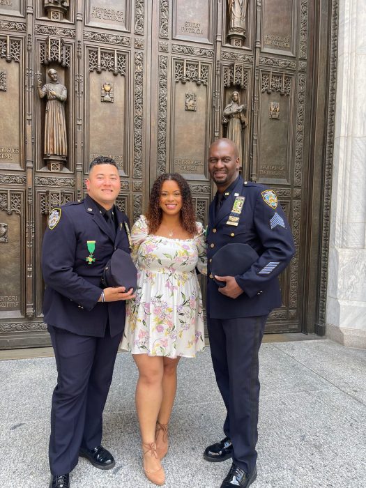 daughter of Miosotis Familia with two uniformed NYPD officers