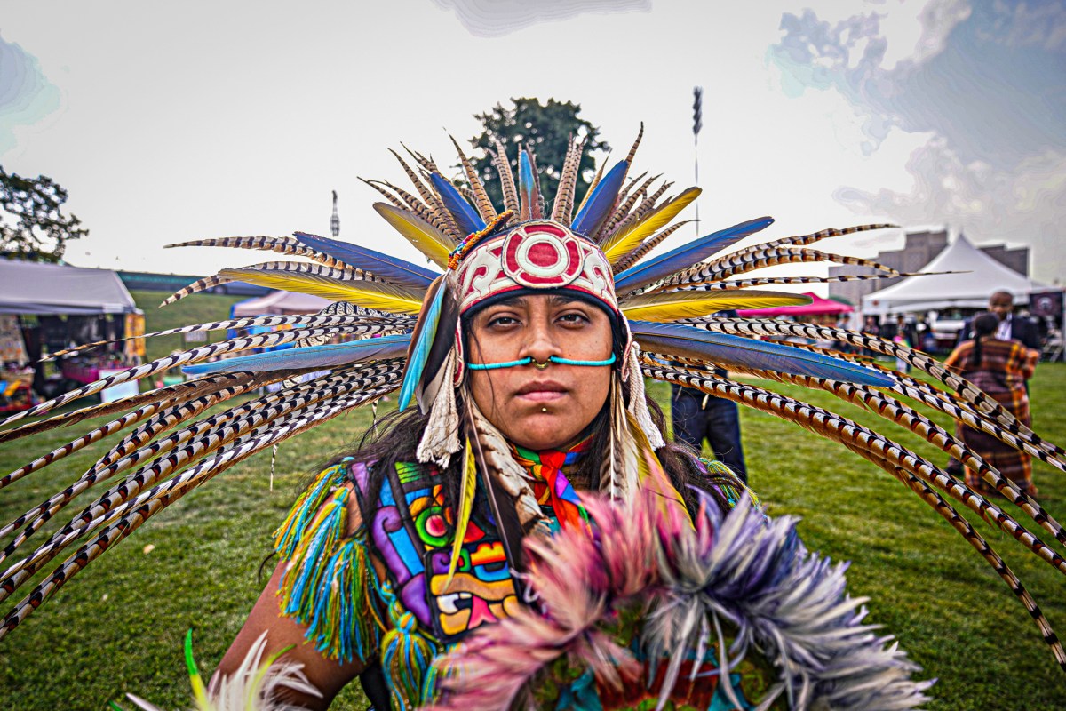 Native American man wearing feather headdress on Indigenous Peoples Day