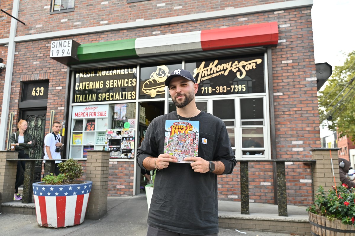 Nicolas Heller, aka New York Nico, holds his book.