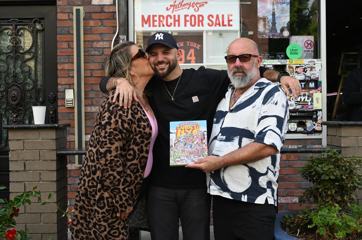 Nicolas Heller and his parents with his book