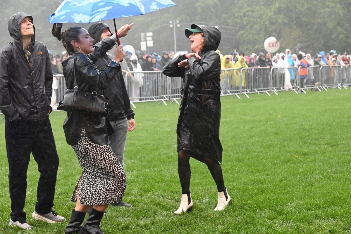 Fans dance in the rain