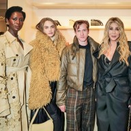 four people at a reopened Burberry flagship store in Midtown