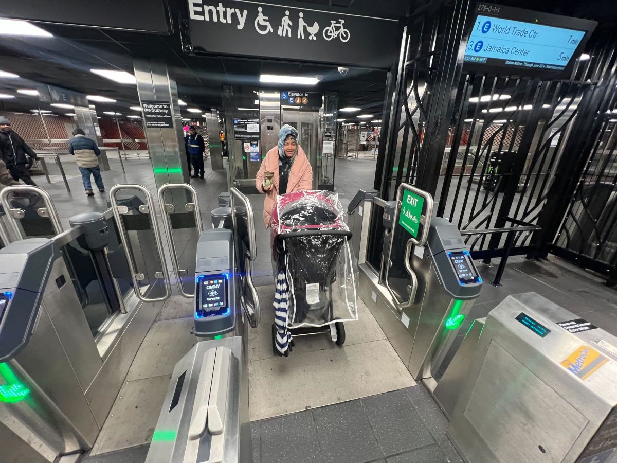 Mom goes through open turnstiles