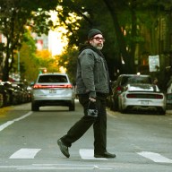 Photographer Reuben Radding crossing street in Abbey Road style