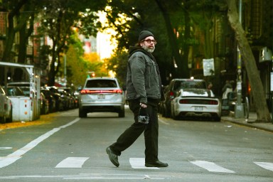 Photographer Reuben Radding crossing street in Abbey Road style