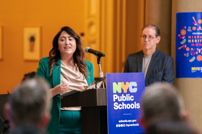 incoming NYC public schools chancellor Melissa Aviles-Ramos wearing a green jacket at a podium