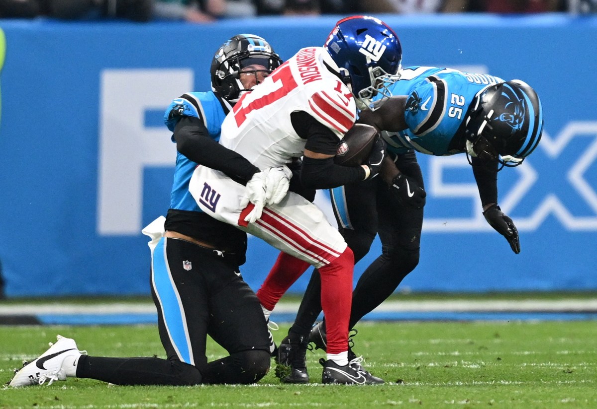 Giants' Dale Robinson gets wrapped up by the Carolina Panthers during a game in Munich, Germany on Nov. 10, 2024.