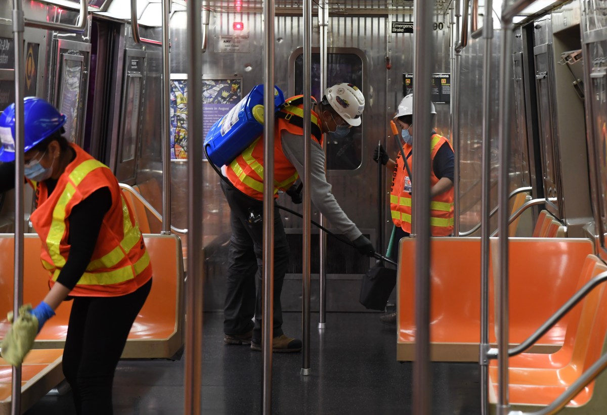 Subway cleaners disinfect train car during pandemic