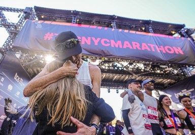 NYC Marathon runner embraces girl at finish line