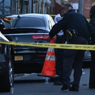 A handgun lays on the ground after a man was shot multiple times.