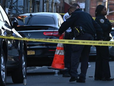 A handgun lays on the ground after a man was shot multiple times.