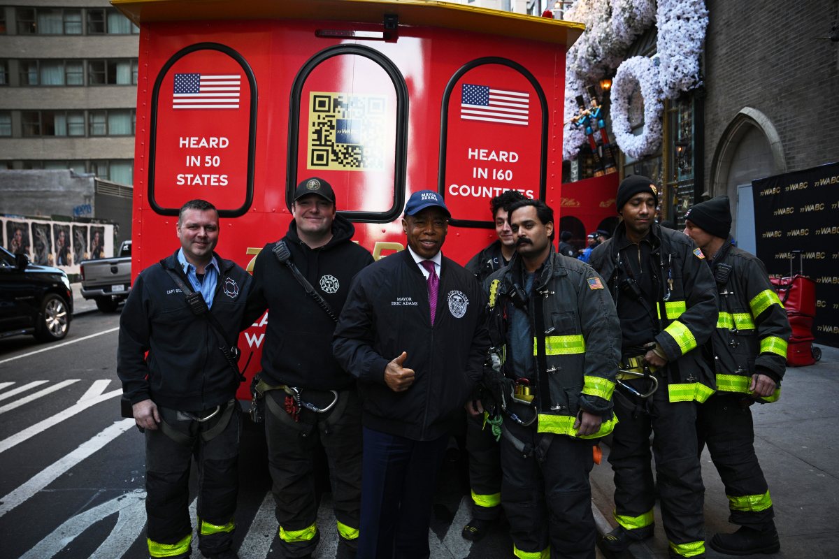 Mayor Eric Adams poses with Firefighters from Engine Company 54 during a turkey giveaway ahead of Thanksgiving  at St. Malachy’s Church.