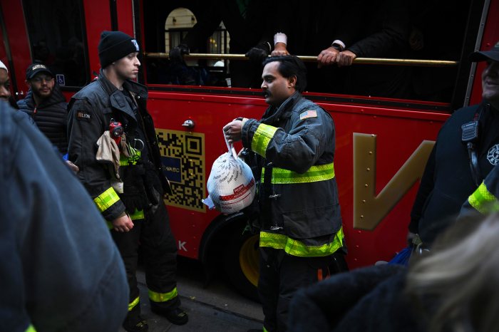 Members of the FDNY hand out turkeys in Manhattan.