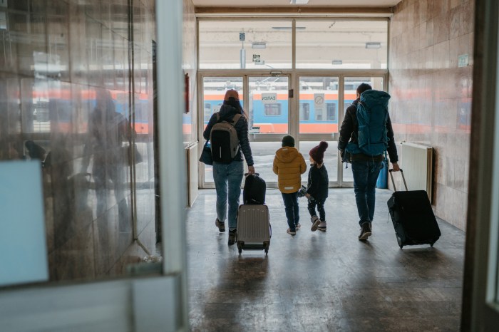 Family with two children at the train station