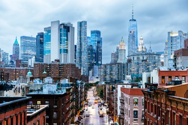 Illuminated Manhattan Financial District skyscrapers seen from Chinatown, New York City, USA