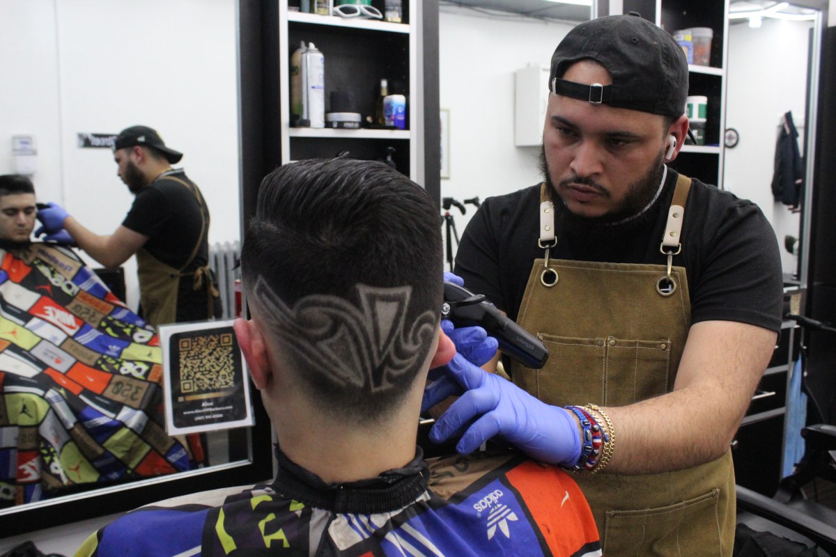 Alexander Rodriguez gives a haircut in his Harlem barbershop.