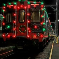 Metro-North Holiday Lights Train at night decorated with red and green lights