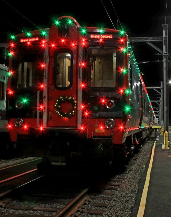 Metro-North Holiday Lights Train at night decorated with red and green lights