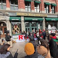 workers rally outside holding signs in front of Barnes & Noble