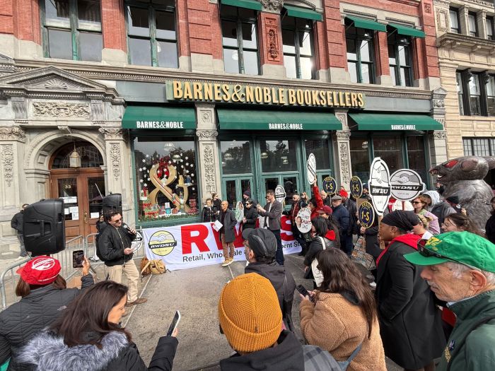 workers rally outside holding signs in front of Barnes & Noble