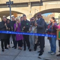 DOT officials, elected officials and transportation advocates cut the ribbon for the Queens Boulevard Redesign. Photo: Shane O’Brien