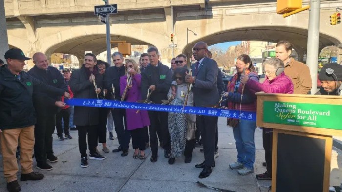 DOT officials, elected officials and transportation advocates cut the ribbon for the Queens Boulevard Redesign. Photo: Shane O’Brien