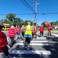 people walking across a crosswalk