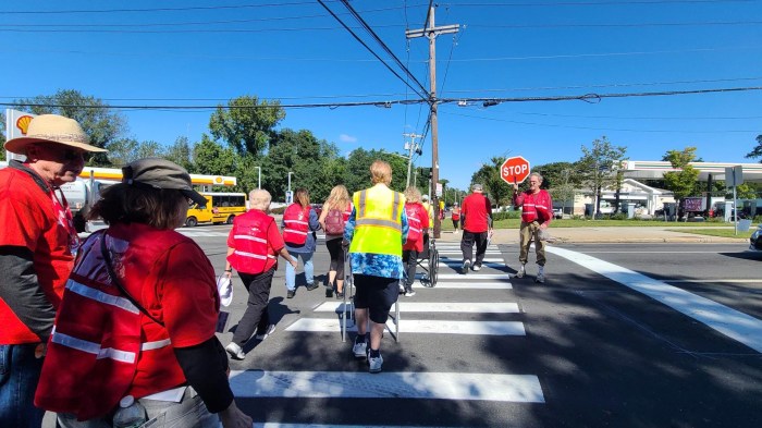 people walking across a crosswalk