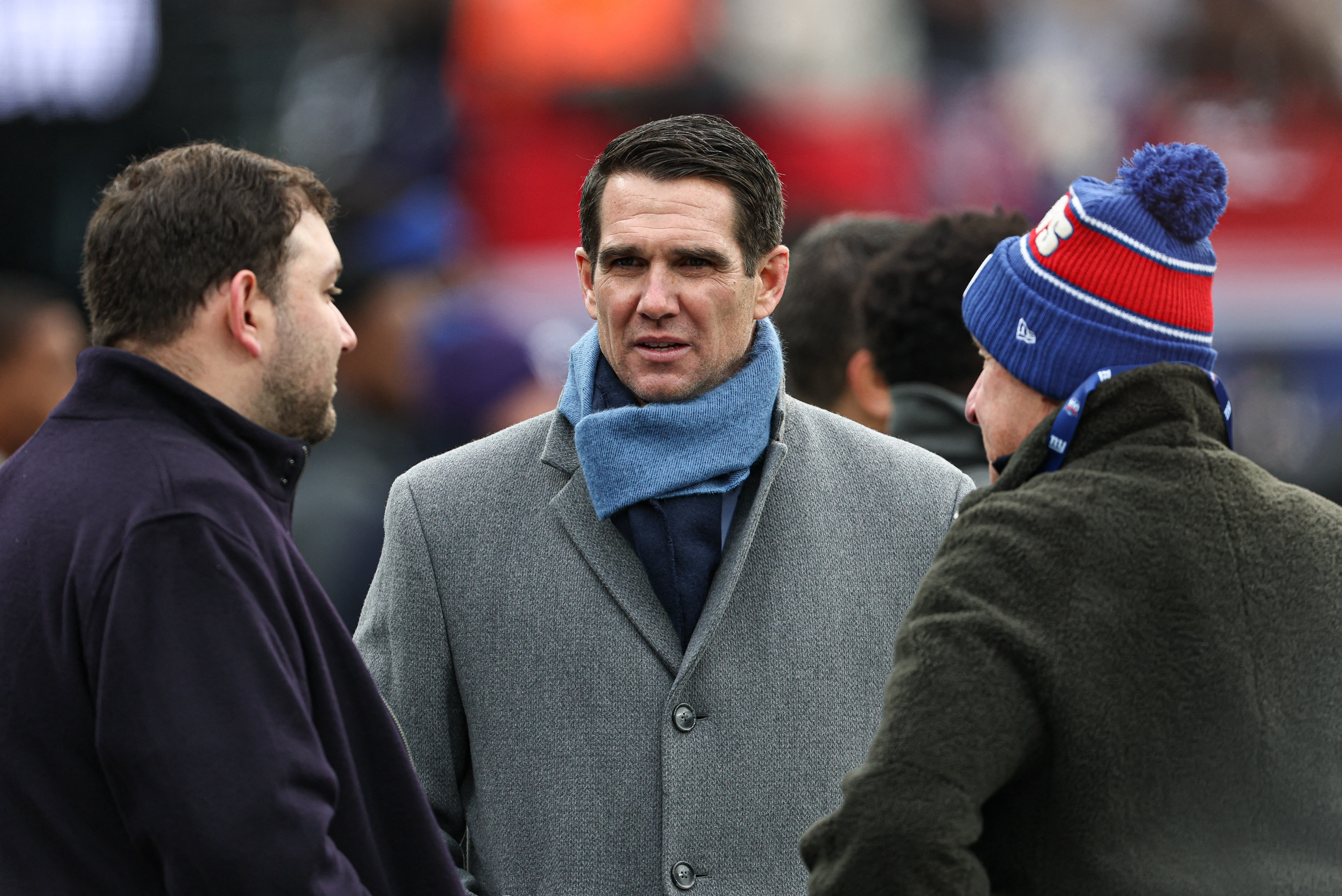 East Rutherford, New Jersey, USA; New York Giants general manager Joe Schoen, center, on the field before the game against the Baltimore Ravens at MetLife Stadium.