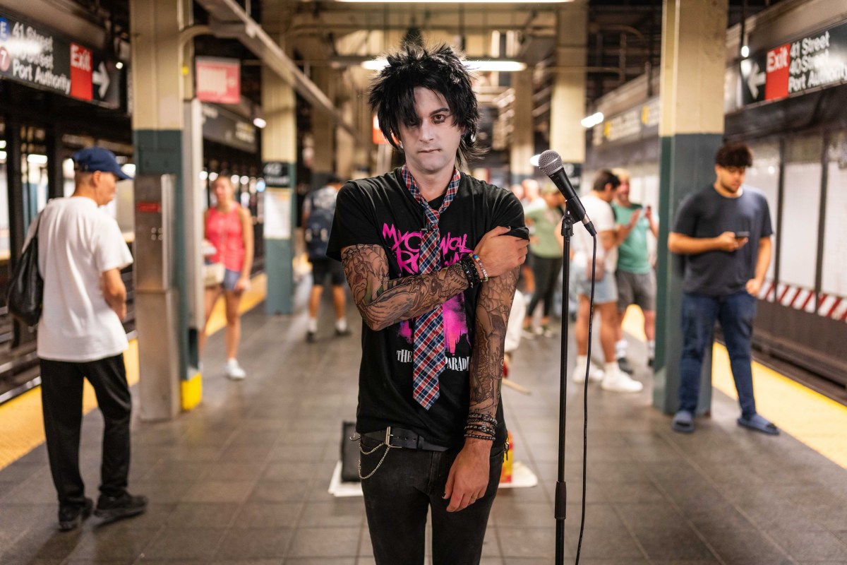 Marcus Monroe on a NYC train platform dressed in black