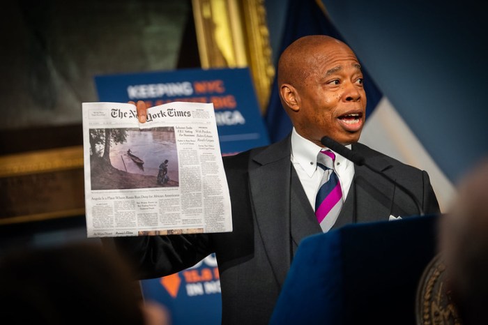 Mayor Adams holds up copy of New York Times