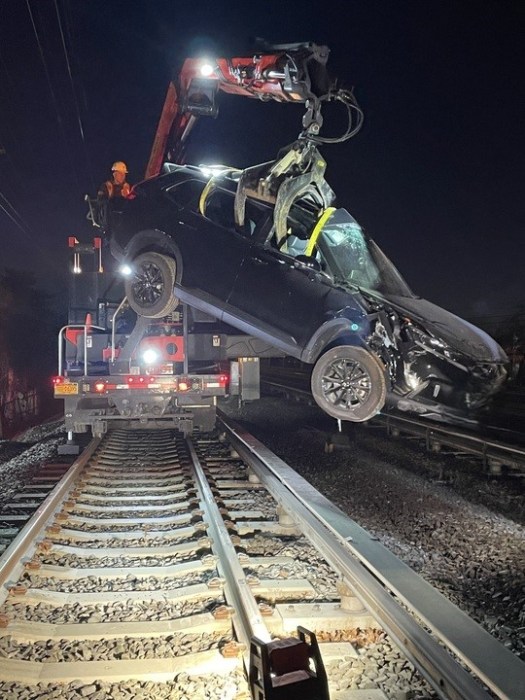 a hydraulic lift takes an SUV off the tracks of the LIRR