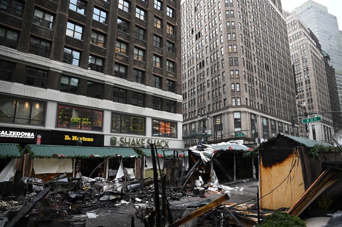 A fire heavily damaged several booths at the Herald Holiday Market.