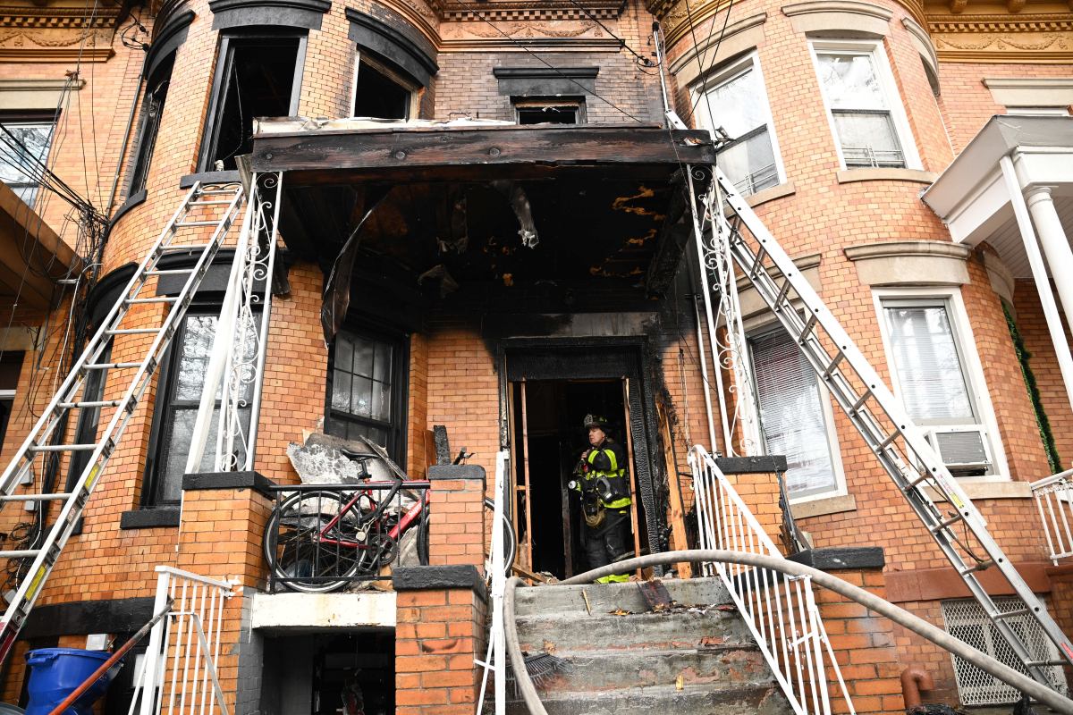 Firefighter outside Queens fire location