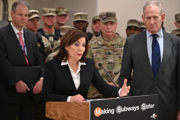 people at a podium during press conference about National Guard troops in NYC subways and NYC subway safety