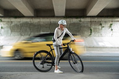 bicycle riding in the city of Vancouver on an ebike with a battery powered commuter bike through the city of vancouver, gastown, stanley park with views of downtown city skyline.