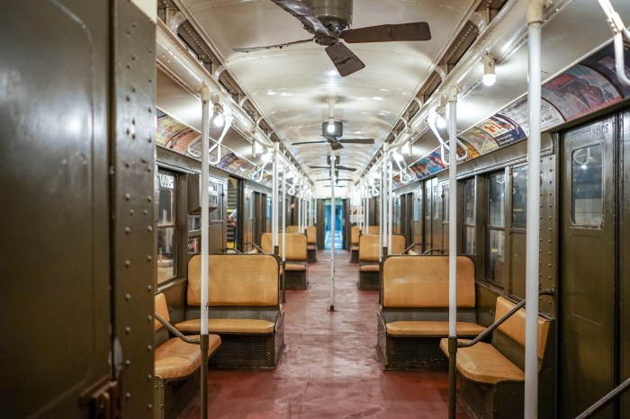 Inside a vintage train in NYC that has rattan seats