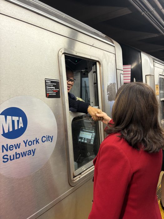 Governor Hochul greets train conductor.