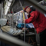 Guardian Angels Curtis Sliwa with homeless man on subway train