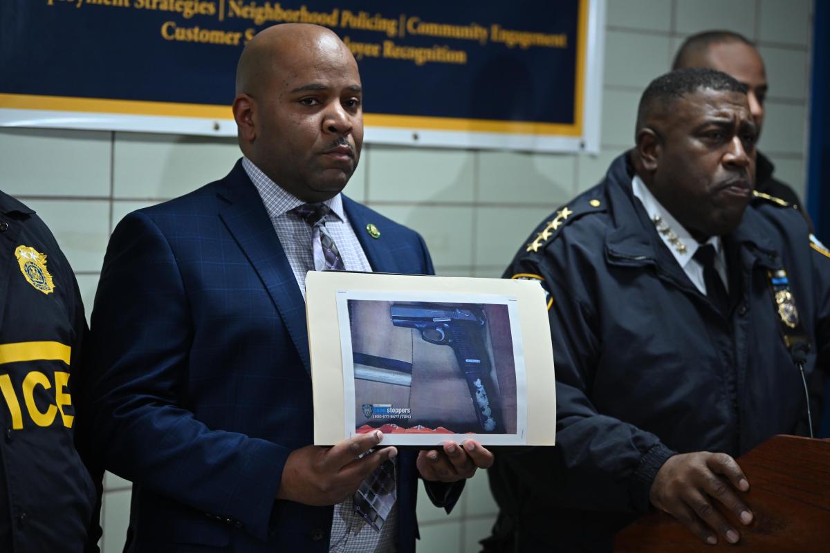 Police officials hold up the photo of the gun allegedly apprehended from a male suspect killed in a Brooklyn police-involved shooting on Dec. 5, 2024.