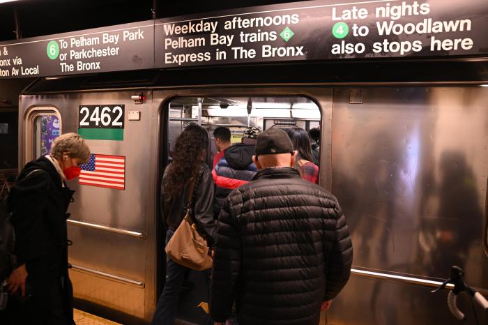 people boarding a Manhattan subway train