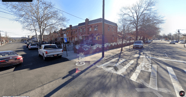 intersection in the Bronx in Eastchester showing a crosswalk and cars