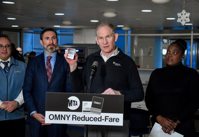 people at a podium with one person holding up a reduced-fare OMNY card