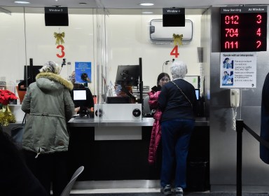 Customers at an MTA customer service center where reduced-fare OMNY is available